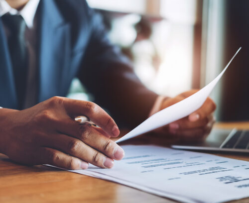 hr audit resume applicant paper and interview with using pen and computer laptop for selection human resource to company. Lawyer Reading Document At Desk